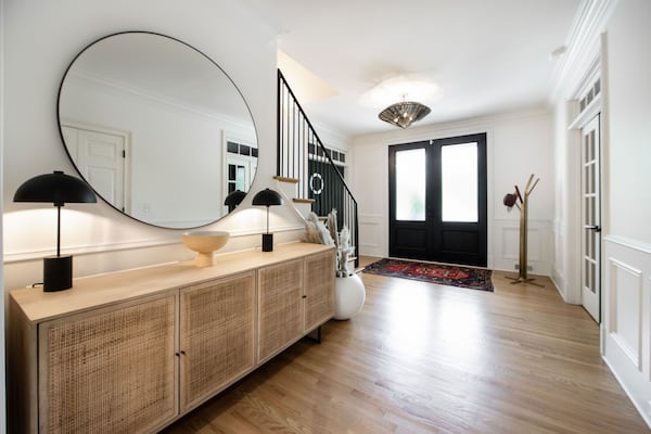 “When I walked in the first time, the foyer was pretty small and dingy,” Rachel Nelson says, but a coat of Benjamin Moore Decorator’s White and some contrasting accents (from the repainted rails to the A Plus Store Lamps) did wonders for creating a clean and inviting entryway. The original antique beveled glass entrance was also swapped out for these black double doors. Text by Lori Keong/Photo by Amanda Winchester