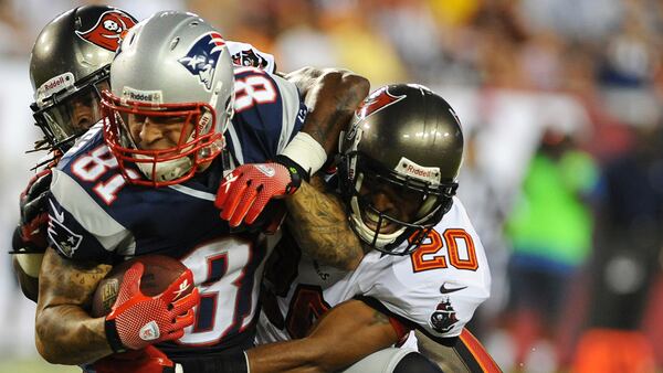 Defensive back Ronde Barber #20 of the Tampa Bay Buccaneers #20 tackles tight end Aaron Hernendez #81 of the New England Patriots at Raymond James Stadium in a pre-season game August 24, 2012  in Tampa, Florida. (Photo by Al Messerschmidt/Getty Images)