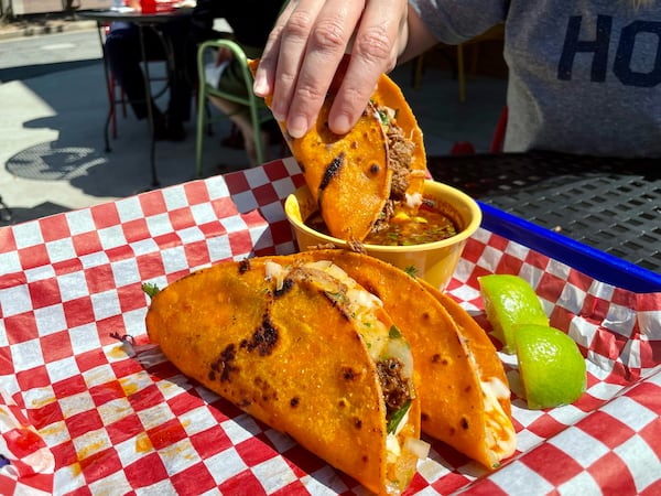 Birria tacos and consommé for dipping at Frida's Taqueria in Lilburn. (Angela Hansberger for The Atlanta Journal-Constitution)