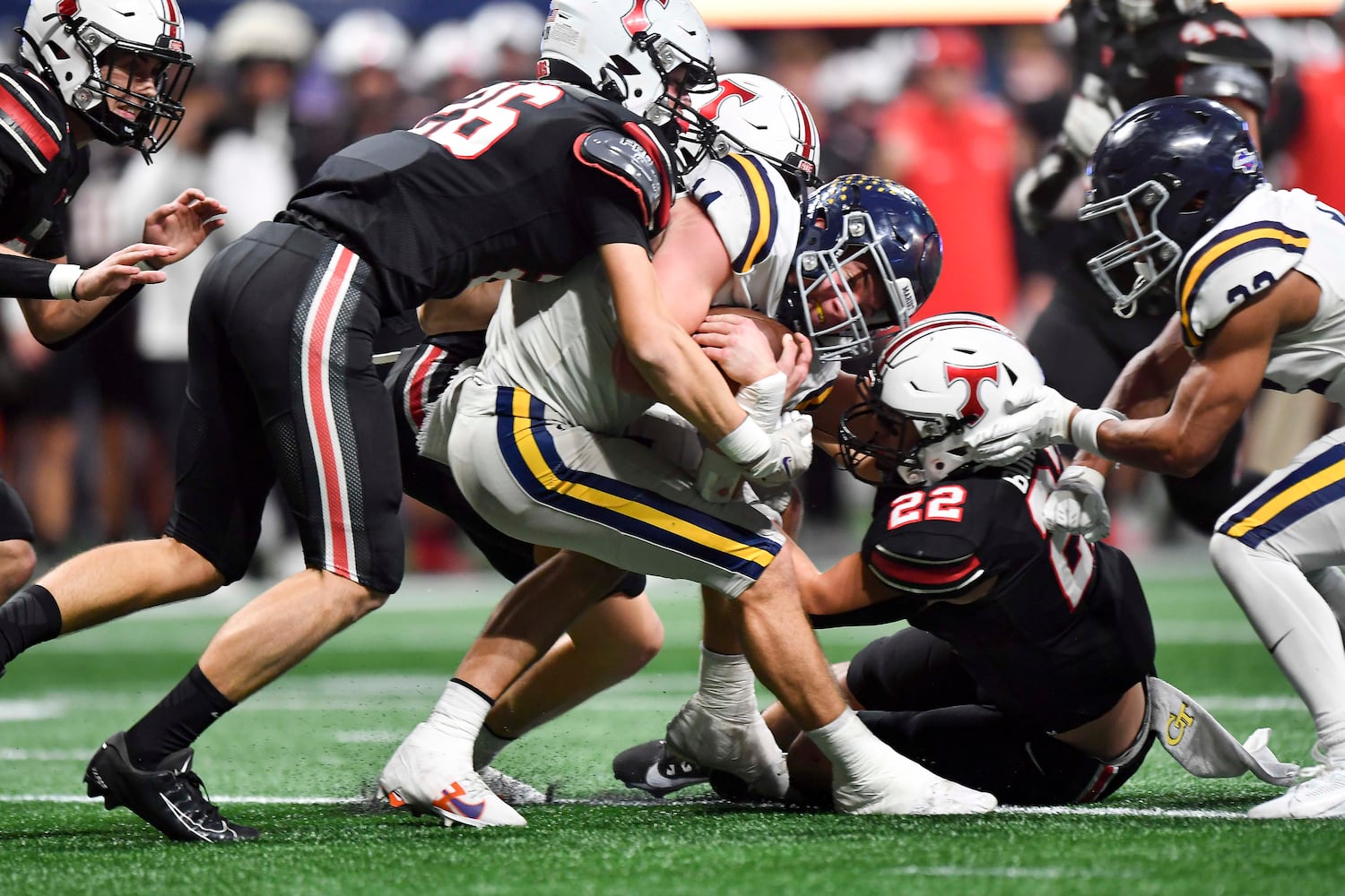 Marist quarterback Jack Euart (14) is tackled by North Oconee’s defense in the red zone during the first half of a Class 4A championship game at the Mercedes-Benz Stadium Monday, Dec. 16, 2024. (Photo/Daniel Varnado)