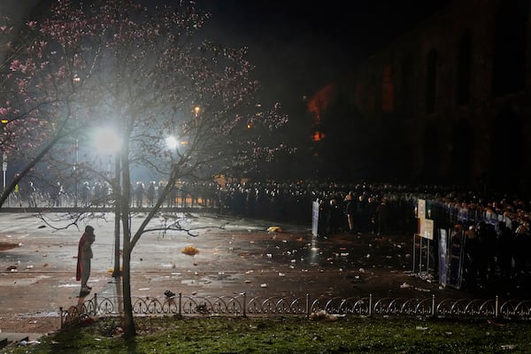 A man stands in front of anti riot police officers during clashes in a rally against the arrest of Istanbul's Mayor Ekrem Imamoglu, in Istanbul, Turkey, Friday, March 21, 2025. (AP Photo/Khalil Hamra)