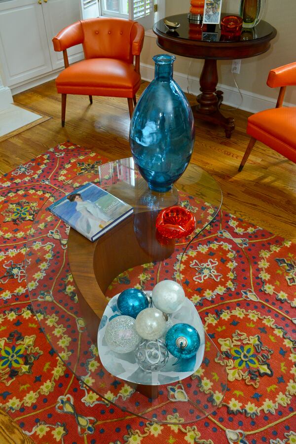 Homeowners Pedro Ayestaran Diaz and Jeffrey Chandler purchased their 1960s comma-shaped coffee table, made of wood and glass by Vladimir Kagan, from Peter Pero at Antique Factory in Chamblee. Text by Lori Johnston and Keith Still/Fast Copy News Service. (Christopher Oquendo Photography/www.ophotography.com)