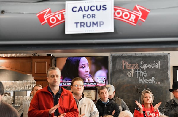 Supporters of  Former President Donald Trump react as Fulton County DA Fani Willis is shown on TV monitor in background during Team Trump Iowa Campaign event ahead of Iowa Caucus at ShinyTop Brewery, Monday, January 15, 2024, in Fort Dodge, Iowa. (Hyosub Shin / Hyosub.Shin@ajc.com)