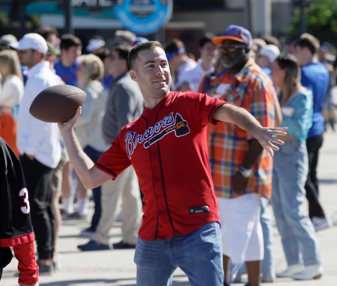 Miles Cox tosses a football with friends before the annual Georgia vs Florida game at TIAA Bank Field in Jacksonville.   Bob Andres / bandres@ajc.com