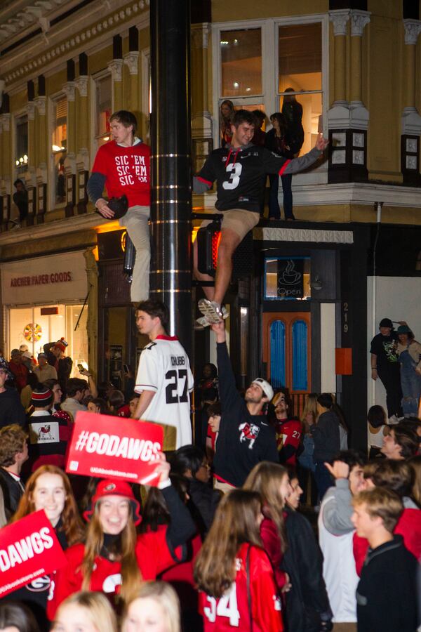 University of Georgia students and fans flood the streets to celebrate a Bulldog victory in the College Football Championship on Monday, January 9, 2023, in downtown Athens, Georgia. The University of Georgia defeated the Texas Christian University football team 65-7. CHRISTINA MATACOTTA FOR THE ATLANTA JOURNAL-CONSTITUTION.