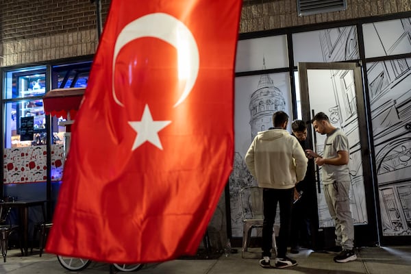 The flag of Turkey hangs as workers take a break from the dinner shift at a Turkish restaurant Wednesday, Nov. 6, 2024, in Dearborn, Mich., the nation's largest Arab-majority city. (AP Photo/David Goldman)