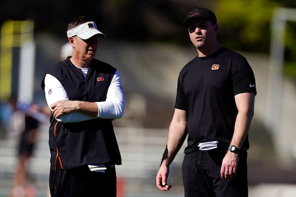 Cincinnati Bengals head coach Zac Taylor, right, talks to defensive coordinator Lou Anarumo during NFL football practice Wednesday, Feb. 9, 2022, in Los Angeles. The Cincinnati Bengals play the Los Angeles Rams in the Super Bowl Feb. 13. (AP Photo/Marcio Jose Sanchez)