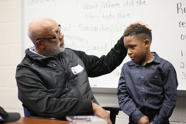 Before John Carlos began his presentation, he shared the spotlight with second-grade student Jeremiah Green, 8, who made a presentation about Carlos’s story at Barack H. Obama Elementary Magnet School of Technology on Wednesday, Feb. 26, 2020 in Atlanta. Jeremiah’s grandfather grew up with John Carlos in Harlem, N.Y. (Photo: MIGUEL MARTINEZ for the AJC)