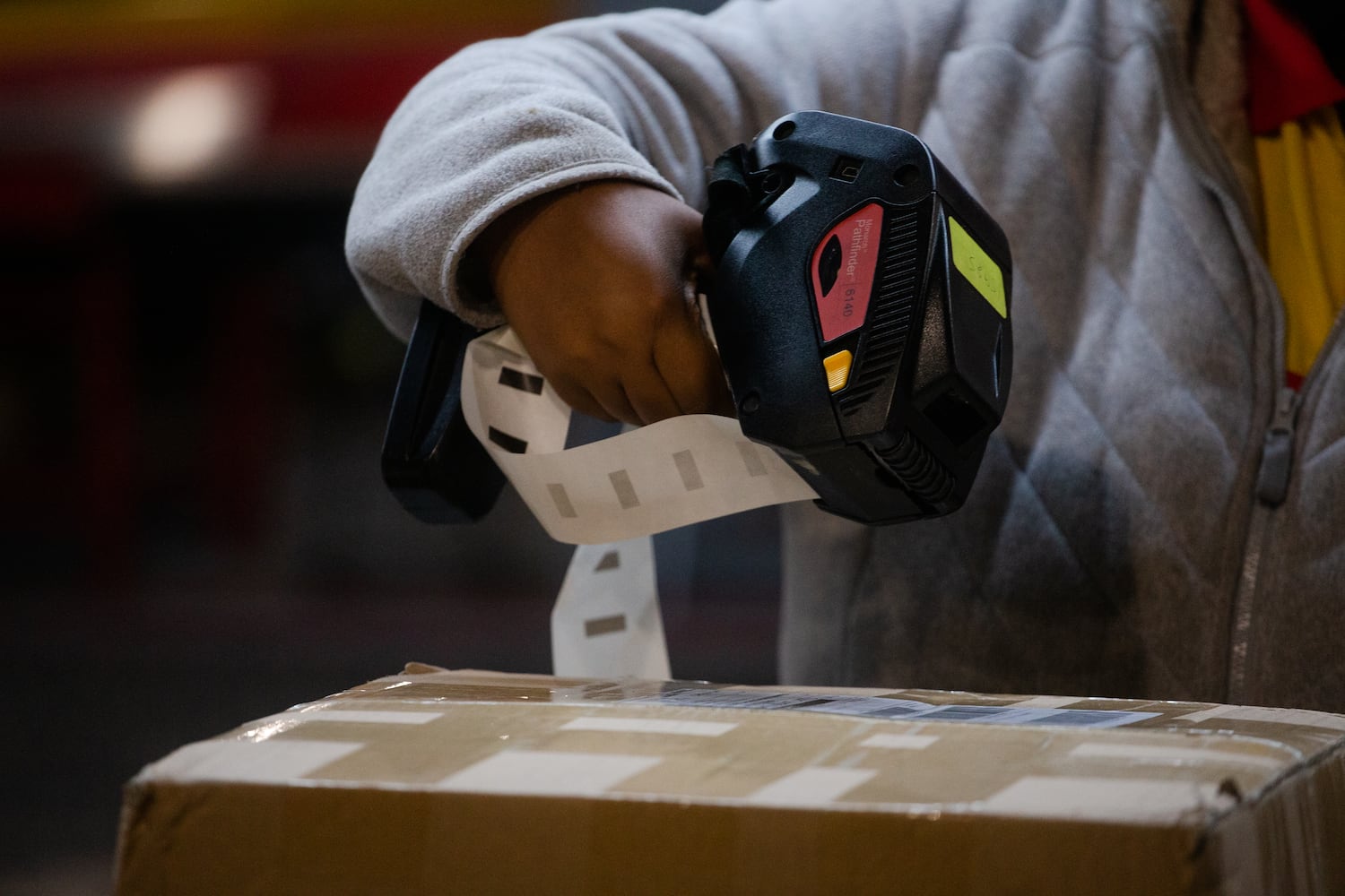 Natasha Garrett labels packages on Wednesday, December 16, 2020, at DHL Express in Atlanta. Workers at the shipping center worked to fulfill orders during the holiday rush. CHRISTINA MATACOTTA FOR THE ATLANTA JOURNAL-CONSTITUTION.