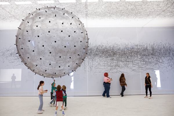 Visitors play with a helium-filled ball in the installation titled “ADA” at the Balloon Museum at Pullman Yards in Atlanta on Monday, Feb. 19, 2024. The exhibit features inflatable installations created by artists from around the world. (Natrice Miller/ Natrice.miller@ajc.com)