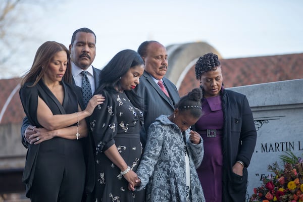 Dexter King, Martin Luther King III and Bernice King are joined by their families as they lay a wreath at their parents' crypt Wednesday evening. ALYSSA POINTER/ALYSSA.POINTER@AJC.COM