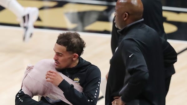 Hawks guard Trae Young comes back in the game during the 4th quarter with his arm and shoulder iced down against the Philadelphia 76ers in game 4 of their NBA Eastern Conference semifinals series on Monday, Jun 14, 2021, in Atlanta.