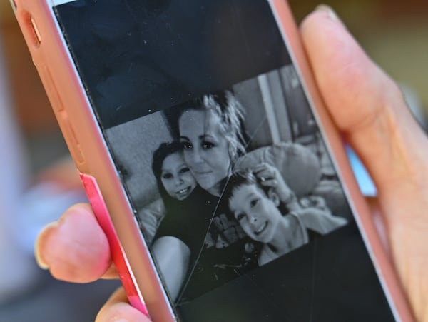 Pamela Dixon shows a picture of her daughter Mary Elizabeth Lewis, who is an inmate in Pulaski State Prison. After repeated extortion calls from the prison threatening her daughter, Dixon says, “It’s gotten to where I see ‘Pulaski’ come up on my phone and I feel like I have PTSD,” (Hyosub Shin / Hyosub.Shin@ajc.com)