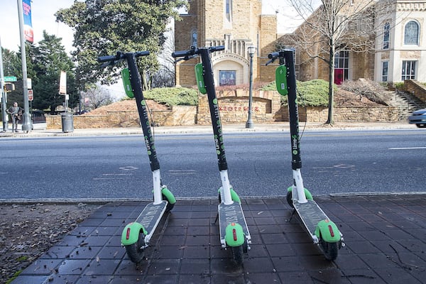 Lime scooters sit parked on the sidewalk on Peachtree Street in Midtown on Jan. 4, 2019. (ALYSSA POINTER/ALYSSA.POINTER@AJC.COM)