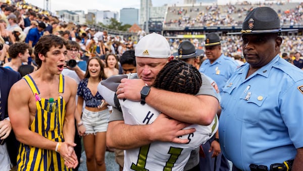 Georgia Tech head coach Brent Key hugs running back Jamal Haynes (11) after an NCAA college football game against Miami, Saturday, Nov. 9, 2024, in Atlanta. (AP Photo/Jason Allen)