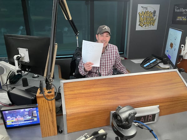 WSB Radio morning host Mark Arum displays his old-school listing of the upcoming show in 2023. BILL TORPY/AJC.COM