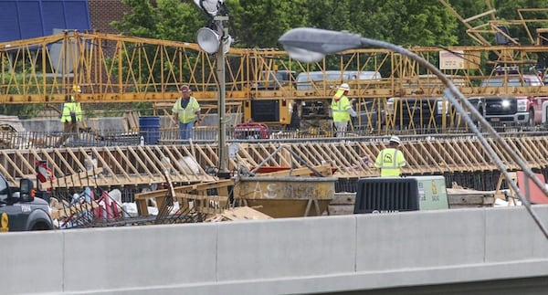 Since a fire led to the collapse of a segment of I-85 in Buckhead March 30, the Georgia Department of Transportation has scrambled to reopen the vital stretch of highway into the heart of Atlanta. Officials now say the collapsed bridge will open May 26, ahead of the previous June date. JOHN SPINK / JSPINK@AJC.COM