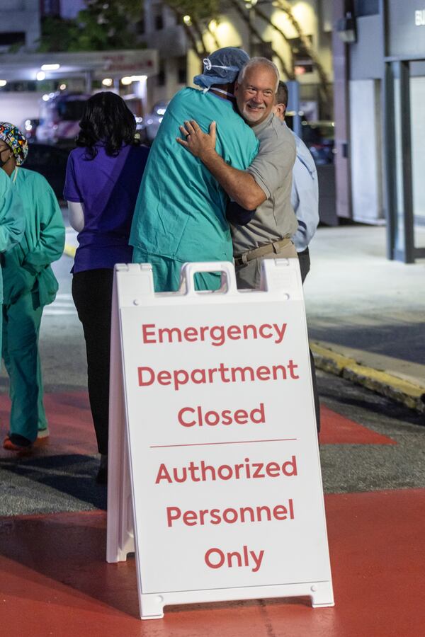 After the emergency room at Wellstar Atlanta Medical Center stopped taking patients, employees gathered outside the hospital in Atlanta Friday morning, October 14, 2022.   Steve Schaefer/steve.schaefer@ajc.com)