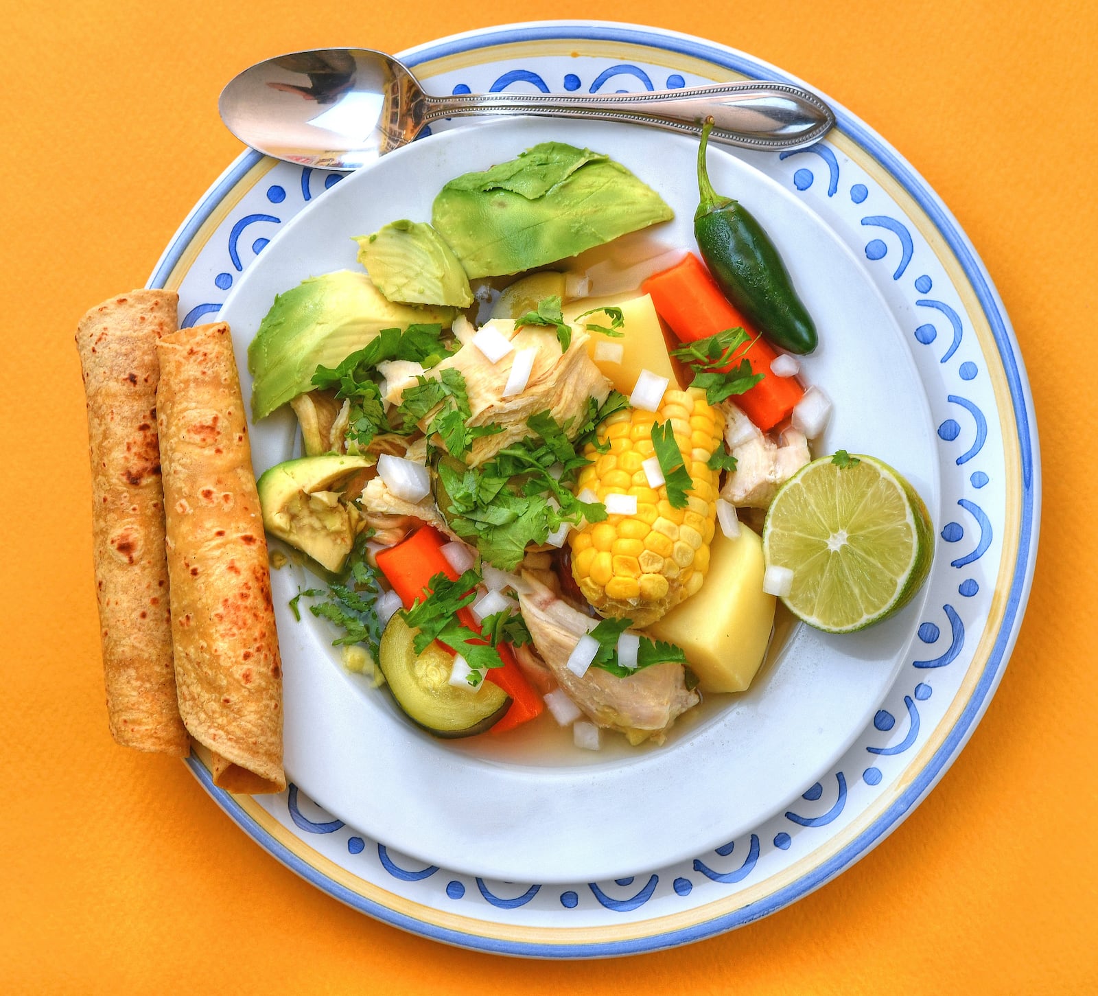 Plenty of flavors, including cilantro, jalapenos, avocado and lime, come together in Mexican Chicken Soup, served with corn tortillas. Styling by Jennifer Zyman / photo by Chris Hunt for the AJC