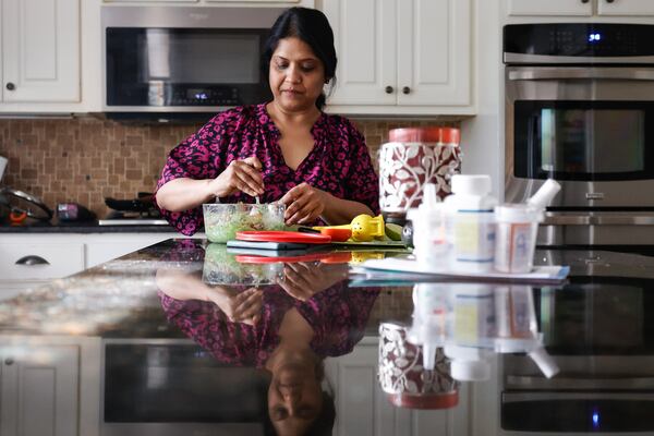 Sowmya Siragowni prepares dinner at her home in Alpharetta on Wednesday, Oct. 25, 2023. Siragowni, a hospitalist at Emory Saint Joseph’s hospital, was diagnosed with stage 4 ovarian cancer five years ago. (Natrice Miller/ Natrice.miller@ajc.com)