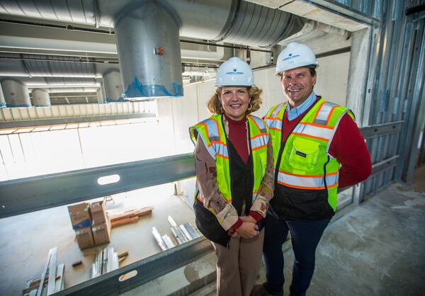 Aurora Theatre's new $31 million theater complex in downtown Lawrenceville is under construction Monday, March 8, 2021.  The theatre's co-founders Ann-Carol Pence, left, and Anthony Rodriguez, right, tour the area above the smaller second theater, the cabaret space, which has folding glass walls opening the space to the outdoor courtyard and available as a rented venue. (Jenni Girtman for The Atlanta Journal-Constitution)