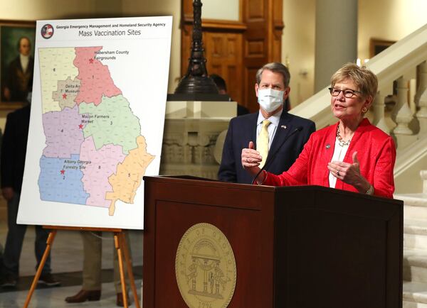 021821 Atlanta: Dr. Kathleen Toomey speaks with Governor Brian P. Kemp looking on during an announcement launching mass vaccination sites amid supply shortage on Thursday, Feb. 18, 2021, in Atlanta.   Curtis Compton / Curtis.Compton@ajc.com”