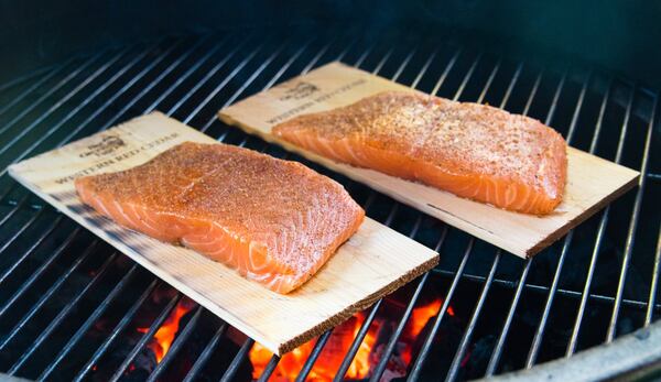 Cedar plank salmon over the fire on a Big Green Egg. 