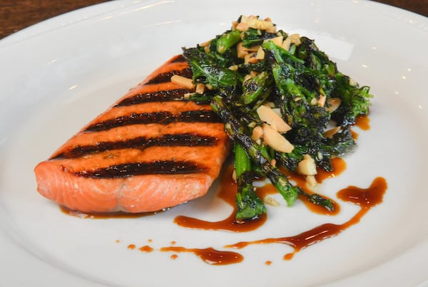 Grilled Salmon with Rapini, from Kevin Gillespie’s cookbook “Fire in My Belly: Real Cooking,” would make a nice spring meal, and Gillespie says it pairs well with Bainbridge Kommuter Kolsch. STYLING BY KEVIN GILLESPIE / CONTRIBUTED BY CHRIS HUNT PHOTOGRAPHY