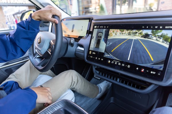 A Rivian employee gives a demo drive of a Rivian R1S SUV from the company’s new showroom at Ponce City Market in Atlanta on Thursday, October 19, 2023. (Arvin Temkar / arvin.temkar@ajc.com)