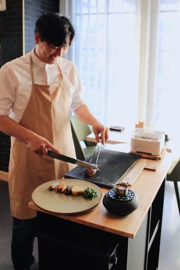 Jason Liang is show preparing wagyu steak tableside at Brush in Buckhead. / Courtesy of Jason Liang