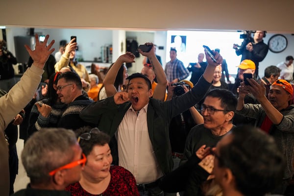 Members of the Naleraq party celebrate during a party after parliamentary elections in Nuuk, Greenland, Tuesday, March 11, 2025. (AP Photo/Evgeniy Maloletka)