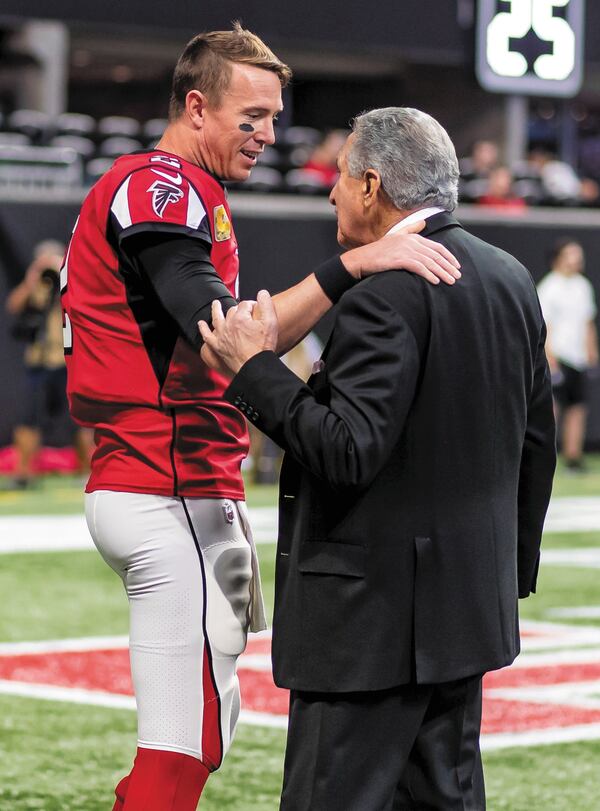 Arthur Blank, owner of the Atlanta Falcons, speaks to quarterback Matt Ryan before a game.