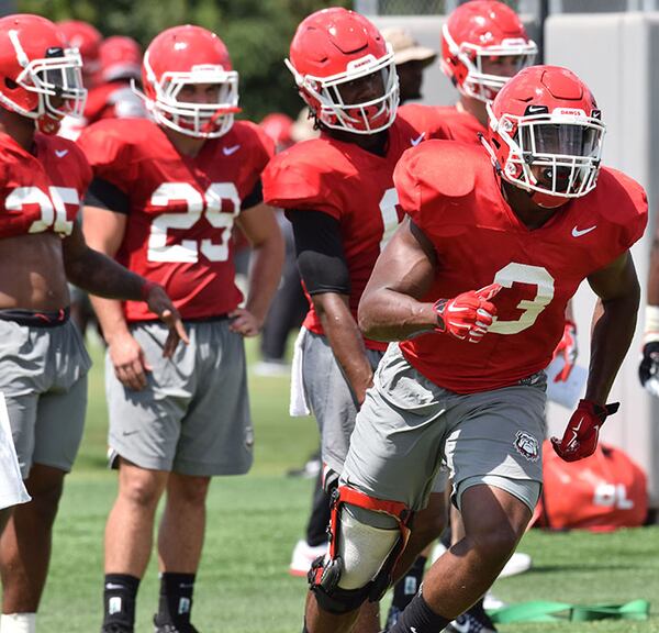 Georgia tailback Zamir White (3), dons a knee brace as he takes part in drills during the Bulldogs' practice Monday, Aug. 6, 2018, in Athens.