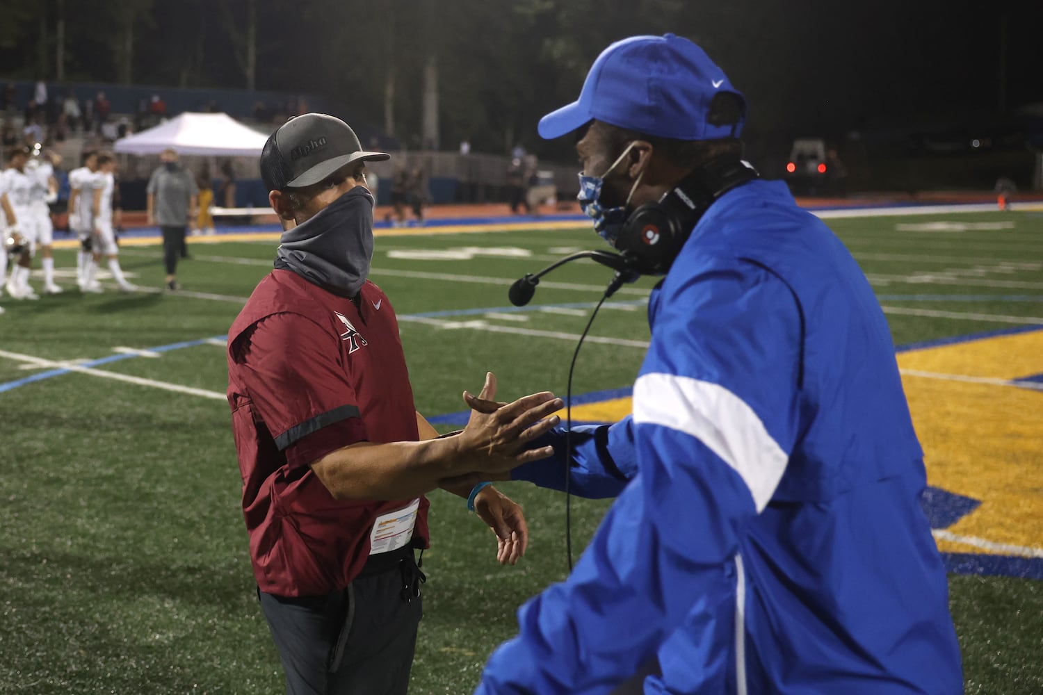 Alpharetta head coach Jason Kervin, left, greets Chattahoochee head coach Mike Malone after AlpharettaÕs 21-7 win against Chattahoochee at Chattahoochee high school Friday, September 25, 2020 in Johns Creek, Ga. Alpharetta won 21-7. JASON GETZ FOR THE ATLANTA JOURNAL-CONSTITUTION