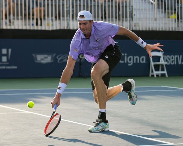 John Isner returns a serve from Brandon Nakashima during the single's final at the Truist Atlanta Open Sunday, Aug. 1, 2021 at Atlantic Station in Atlanta. (Daniel Varnado/For the AJC)