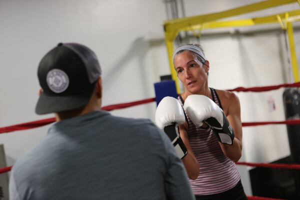 “Boxing is a sport, but it is more than that,” writes AJC dining editor Ligaya Figueras, who took up boxing for training last year. “It is a dance. It is exertion, mental and physical. It is total focus. It is asking your whole self to do things you did not know you could ask of it.” TYSON A. HORNE / TYSON.HORNE@AJC.COM