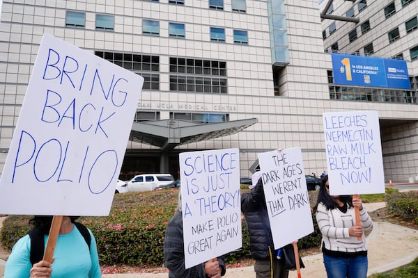 Demonstrators hold signs to protest the nomination of Robert F. Kennedy Jr. as secretary of Health and Human Services outside of the UCLA Medical Center in Los Angeles on Wednesday.