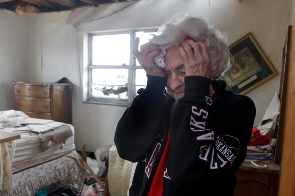 FILE- Florene Renfro, 85, breaks down as she goes through her damaged home Wednesday, May 25, 2011, in Joplin , Mo. (AP Photo/Jeff Roberson, File)