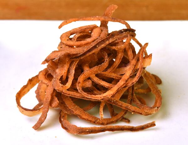 Tobacco Onions, part of 1910 Public House's Western Cowboy Burger, are named for the color the onions turn when cooked. (Styling by executive chef Christian Speigal / Chris Hunt for the AJC)