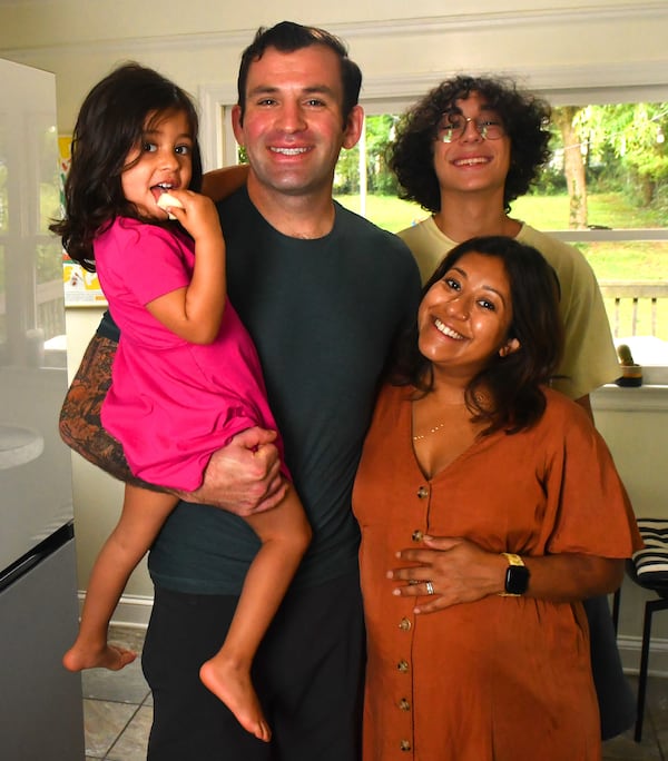 Sahar Siddiqi (right) poses in her Atlanta home with her husband Gabriel Johnson, their 3 1/2-year-old daughter Safina and 15-year-old nephew Isa, who spent the summer living with the family. 
(CHRIS HUNT FOR THE ATLANTA JOURNAL-CONSTITUTION)