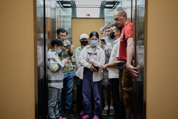 Migrants from Afghanistan, Russia and China, who were deported from the U.S., ride an elevator after visiting the Australian Consulate in Panama City, with the hope to start an asylum application process, Tuesday, March 18, 2025. (AP Photo/Matias Delacroix)