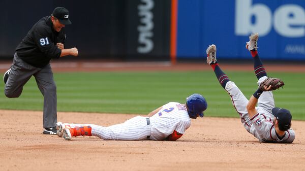 Umpire Brian Knight (91) calls New York Mets first baseman Dominic Smith (2) out at second base after the tag by Braves shortstop Dansby Swanson (7) Thursday, July 29, 2021, in New York. (Noah K. Murray/AP)