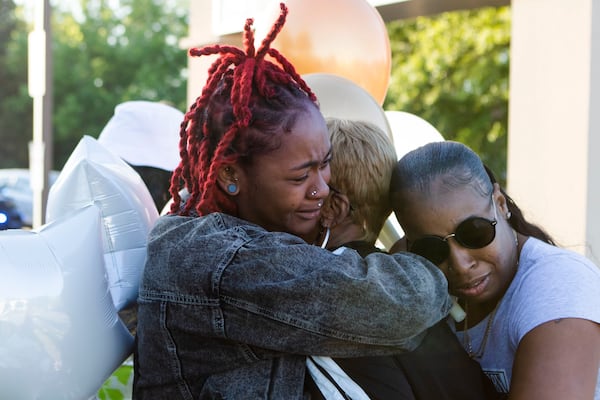 Myla Barlow (left), Bridgett Godfrey (middle) and Poohbella Alford (right) during the candlelight vigil for Koko Da Doll on Saturday, April 22, 2023, in Atlanta. Koko was a Black trans woman who was murdered this week and was the star of "Kokomo City," an upcoming documentary that highlights the experiences of trans sex workers that premiered at the Sundance Film Festival earlier this year. CHRISTINA MATACOTTA FOR THE ATLANTA JOURNAL-CONSTITUTION.