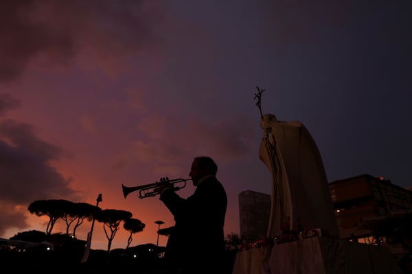 Trumpeter Felice Carella is silhouetted as he plays the song Ave Maria for Pope Francis in front of the Agostino Gemelli Polyclinic, where the Pontiff has been hospitalized since Feb. 14, in Rome, Wednesday, Feb. 26, 2025. (AP Photo/Kirsty Wigglesworth)