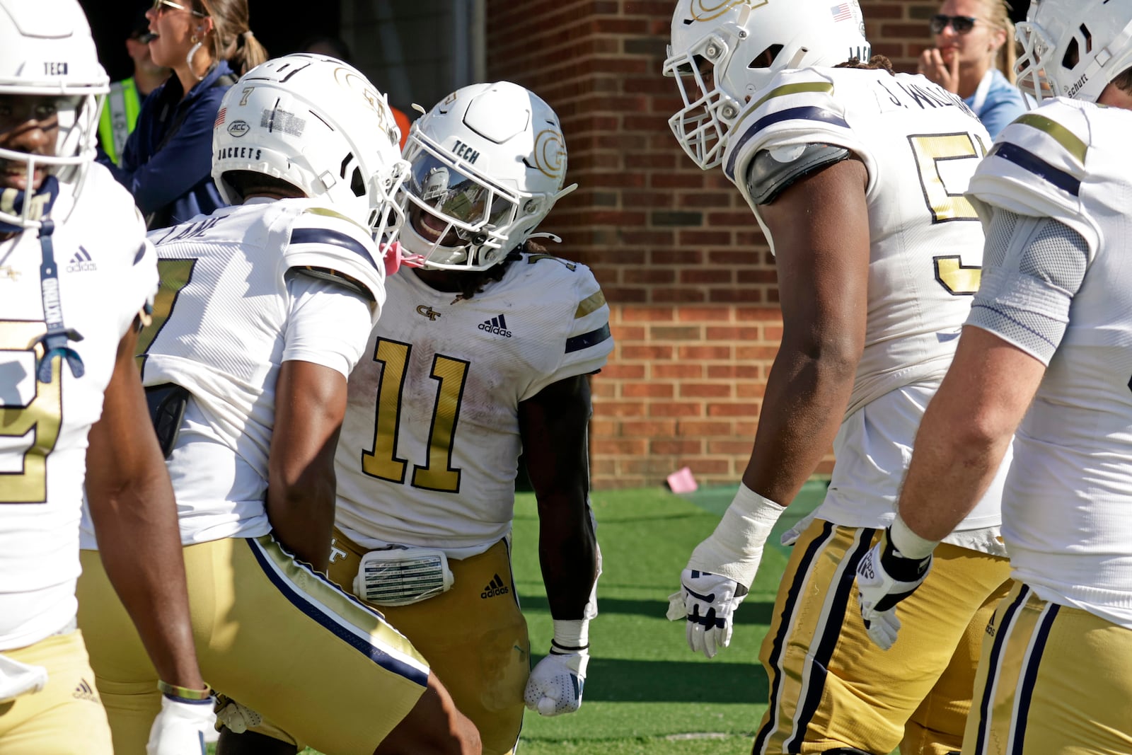 Georgia Tech running back Jamal Haynes (11) celebrates with teammates after he scored the winning touchdown on a long run in the closing seconds of the second half in an NCAA college football game against North Carolina, Saturday, Oct. 12, 2024, in Chapel Hill, N.C. (AP Photo/Chris Seward)