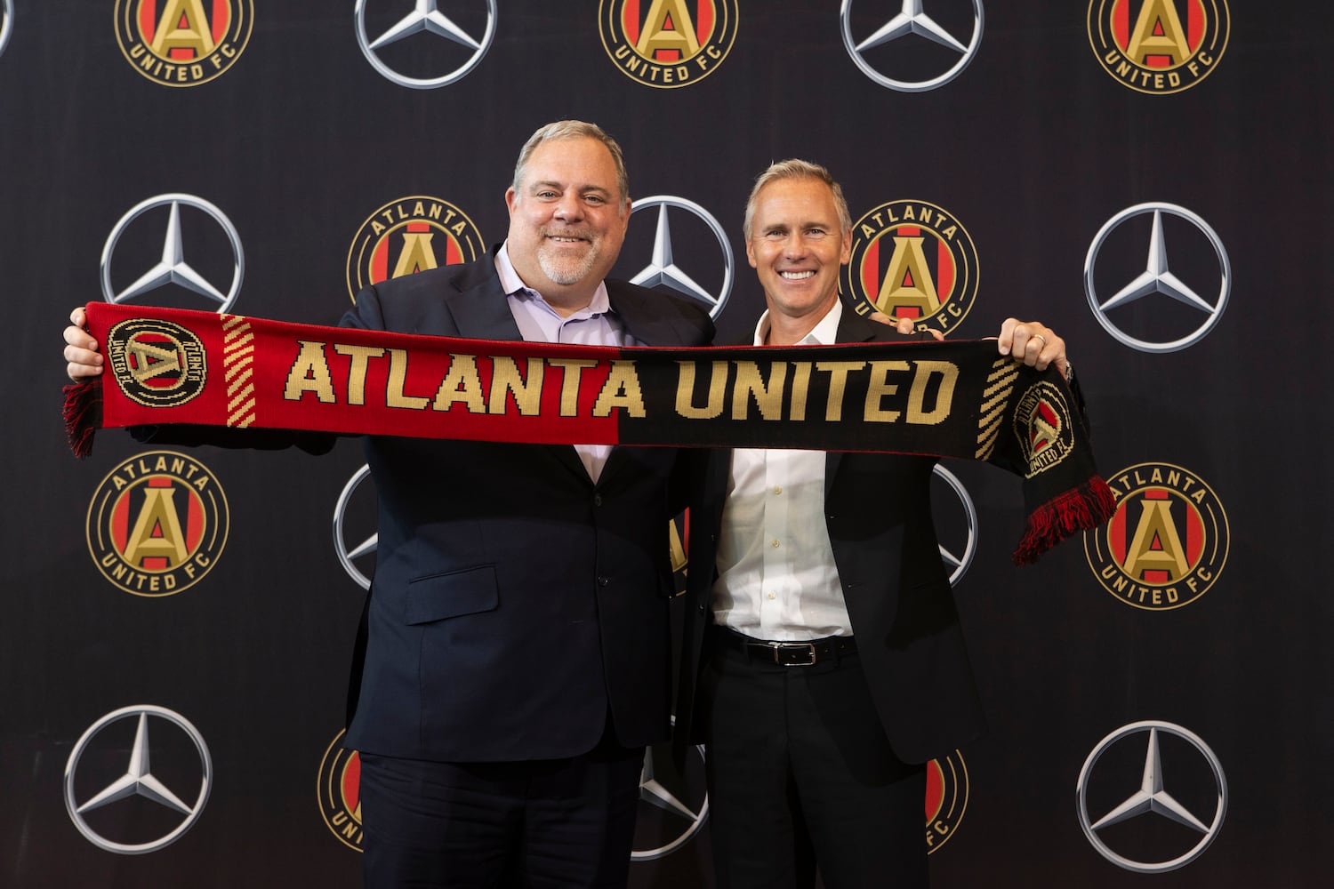 Chris Henderson (right), the newly appointed chief soccer officer and sporting director of Atlanta United, and Garth Lagerwey (left), president and chief executive officer of Atlanta United, pose for a photo during a press conference introducing Henderson as the new technical director on Tuesday, December 17, 2024, at the Atlanta United training grounds in Marietta, Georgia. CHRISTINA MATACOTTA FOR THE ATLANTA-JOURNAL CONSTITUTION.


