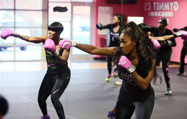 Ellen (left) and Lana Ector lead a morning exercise class at Gymnetics in 2013. BOB ANDRES  / BANDRES@AJC.COM