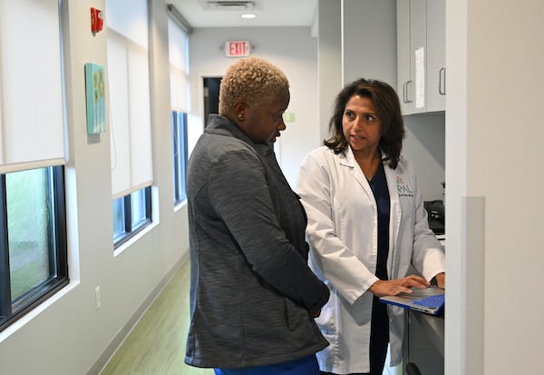 Dr. Anu Sheth, right, checks her daily schedule with her medical assistant, Kelsey Harper-Neely, before the opening hours of the pediatric clinic at Pediatric Associates of Lawrenceville last August. Photo by Hyosub Shin / Hyosub.Shin@ajc.com