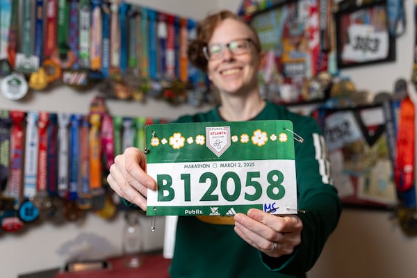 Caroline Burnet poses for a portrait at her home in Atlanta on Friday, February 28, 2025. Burnet will be running her 200th marathon. (Arvin Temkar / AJC)