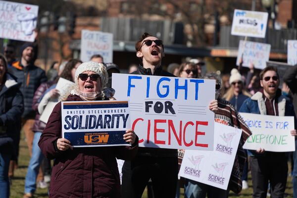 People hold signs during a Stand up for Science rally in Pittsburgh, Friday, March 7, 2025. (AP Photo/Gene J. Puskar)